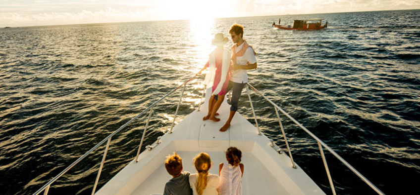 Family Enjoying a Boat Ride during Sunset in the Maldives