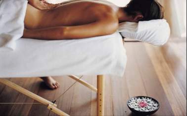 Guest Enjoying a Body Massage at Kandooma Spa