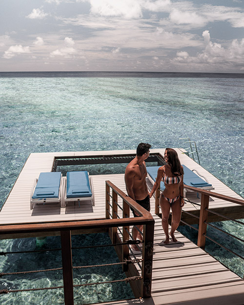 Guests by the Overwater Villa Sundeck